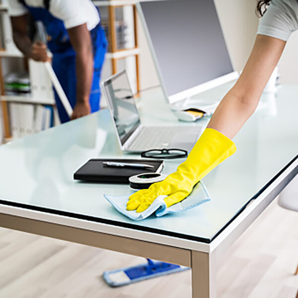 Young Male And Female Cleaners Cleaning Office